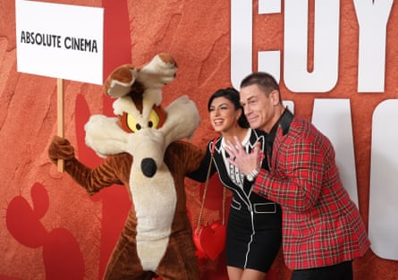 John Cena and his wife Shay Shariatzadeh are joined by an actor in a Wile E Coyote costume