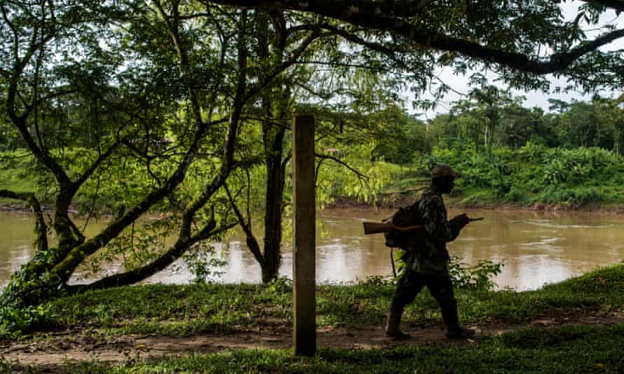 An armed Miskito man on patrol along the bank of the Coco river in Wiwinak, Nicaragua