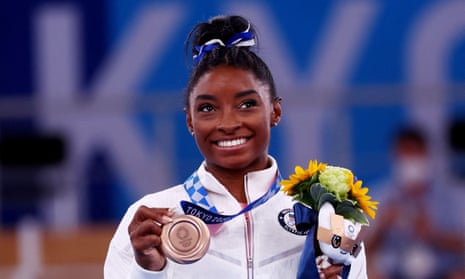 Simone Biles with her bronze medal at the Tokyo Olympics last year.