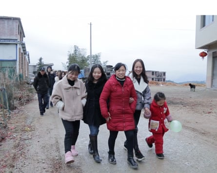 A Chinese family of mother (centre) and three daughters, plus one granddaughter, walking together
