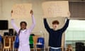 Two children in rehearsal hold up signs with the word 'all rise'