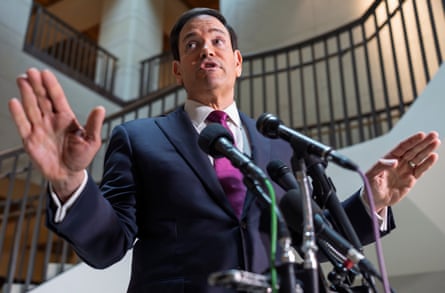 Rubio raises his hands as he speaks to reporters