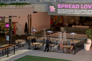 A security officer for Allied Universal, stands guard at The Bloc, an open air plaza in Downtown Los Angeles.