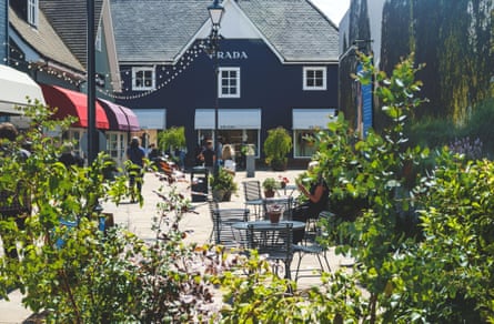 A Prada outlet and outdoor eating area at Bicester Village