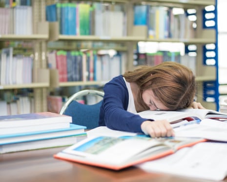 Student falling asleep in a library