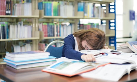 Student falling asleep in a library