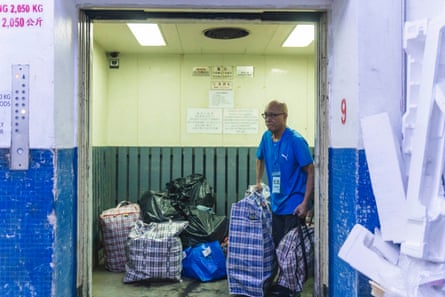 Yik Ka-Kui carries bags of salvaged belongings from his son Yip Shun-Ting Carbon’s fire-ravaged flat at Wang Fuk Court to a mini-storage facility in the nearby Tai Po industrial area.