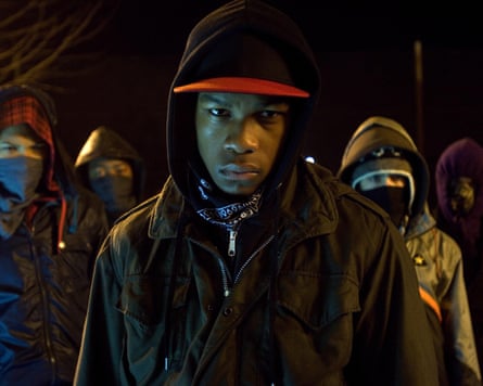 Boyega in 2011 film Attack the Block. He has a hoodie on with a cap underneath and a dark jacket