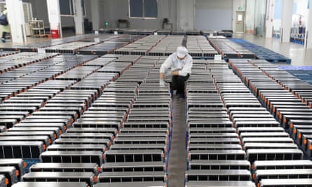A worker with car batteries at a factory in China in 2021.