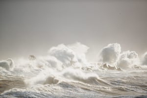 The waves of the North Sea break in front of a beach of Heligoland, Germany.