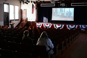 Park workers at the Plains high school and visitor center that becomes part of the Jimmy Carter nationwide historic park see a live broadcast of a funeral on 27 November