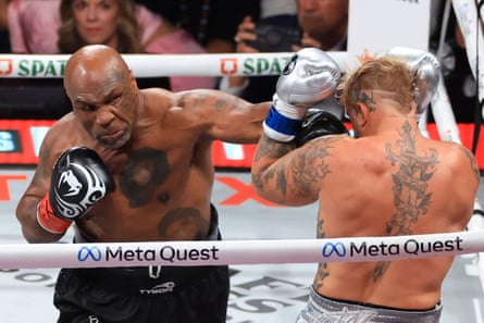 Mike Tyson punches Jake Paul during their heavyweight fight in 2024