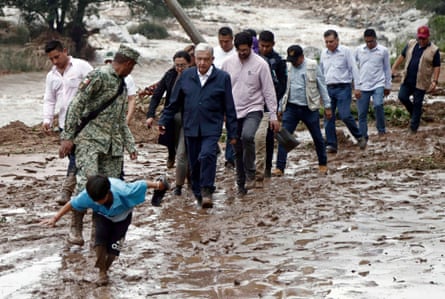 Mexican president Andrés Manuel López Obrador, centre, and members of his cabinet visit the Kilómetro 42 community, 18 miles north of Acapulco in Guerrero state.