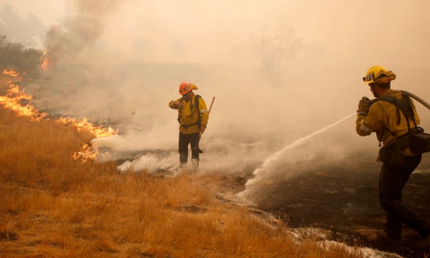 Firefighters work a hotspot caused by the Woosley fire in Malibu, California, on Saturday.