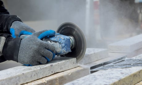 An industrial tool cutting stone on a construction site