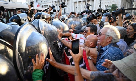 A group of pensioners clash with riot police during a protest outside the Congress in Buenos Aires