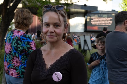 Sarimah Hellyer, wearing a “Be Kind” badge, smiles at a community vigil gathering