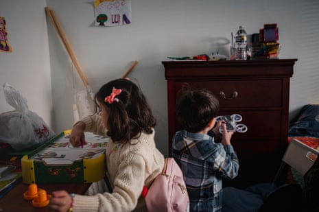 a girl and a boy playing in a room