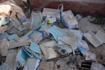 Blue surgical masks among rubble