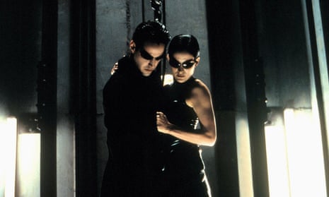 film still of man and a woman dressed in black wearing sunglasses looking down