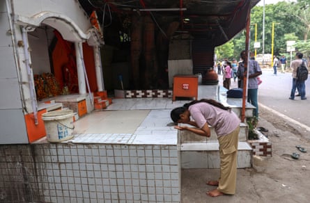 A student bows in front of a shrine to offer prayers as she arrives to take the medical examination at a centre in Delhi, India, 21 June 2026