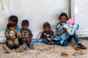 Al-Hol, Syria. Syrian women and children sit by their belongings to wait for departure, as another group of Syrian families is released from the Kurdish-run camp which holds suspected relatives of Islamic State group fighters, in Hasakeh governorate