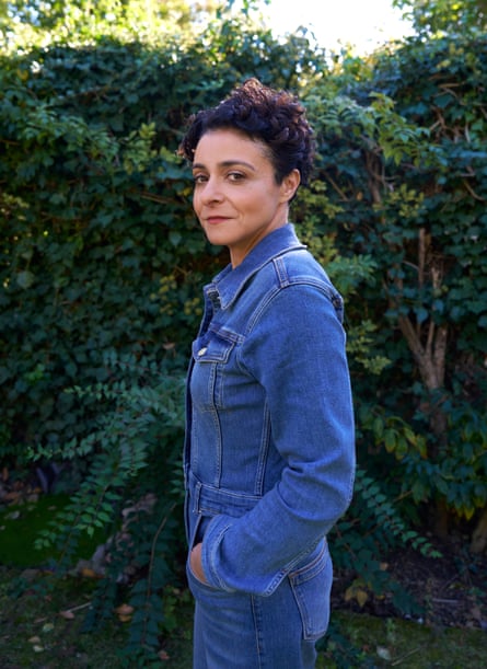 Writer Jenny Kleeman standing in front of a hedge, arms crossed, in denim jumpsuit, Oct 2025