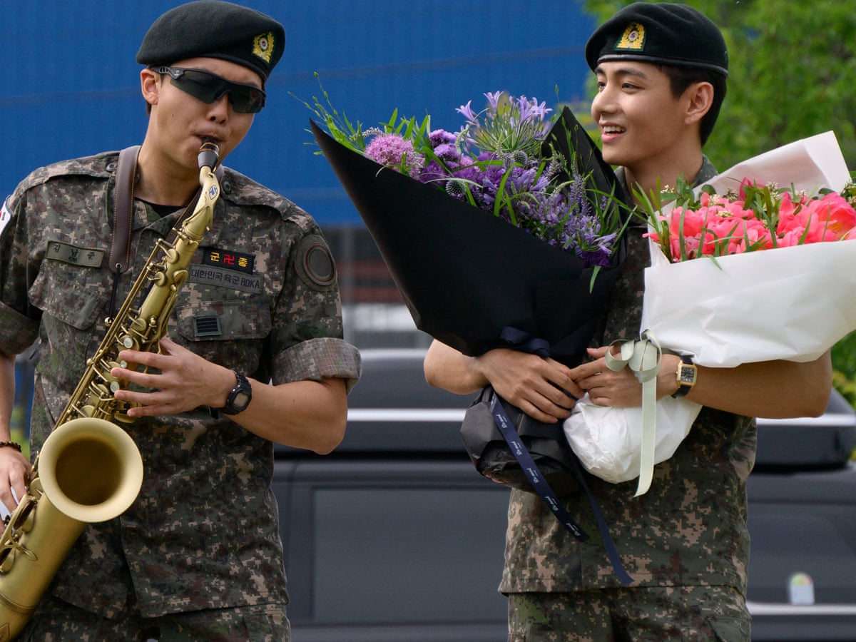 BTS stars RM and V discharged after completing military service in South Korea | BTS | The Guardian