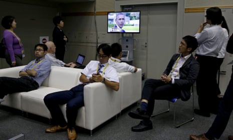 Japanese journalists watch a TV broadcast displaying US president Barack Obama during his visit to the Hiroshima Peace Memorial Park