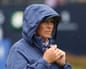 Angela Stanford, the USA captain, clasps her hands in a hooded rain jacket