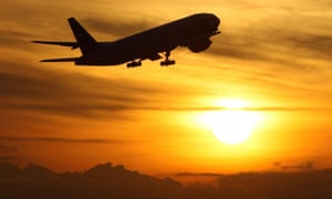A plane taking off at sunset.