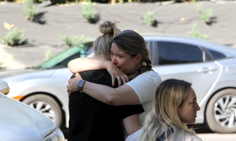 Women affected by the June 28 Russian missile attack on the apartment block share an embrace, Dnipro, east-central Ukraine.