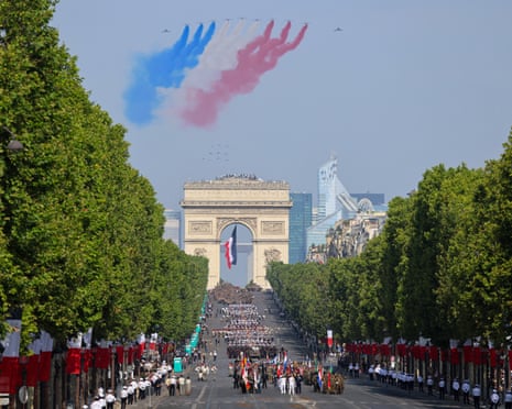 France's Air Force Elite aerobatic flying team "Patrouille de France" (PAF) releases trails of France's national colours as they perform a flyover during the annual Bastille Day military parade on the Champs-Elysees Avenue with the Arc de Triomphe in the background in Paris, France.