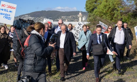 Protesters follow Anthony Albanese at a press conference in Hobart y