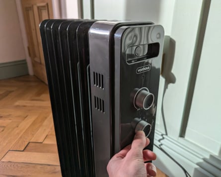 A VonHaus small oil-filled radiator 1,500W being adjusted by the writer