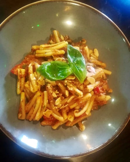 Casarecce pasta, red pepper, almond and smoked garlic pesto, confit onion and basil at Salvo’s.