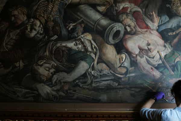 Daniel Maclise mural being cleaned by a conservator.