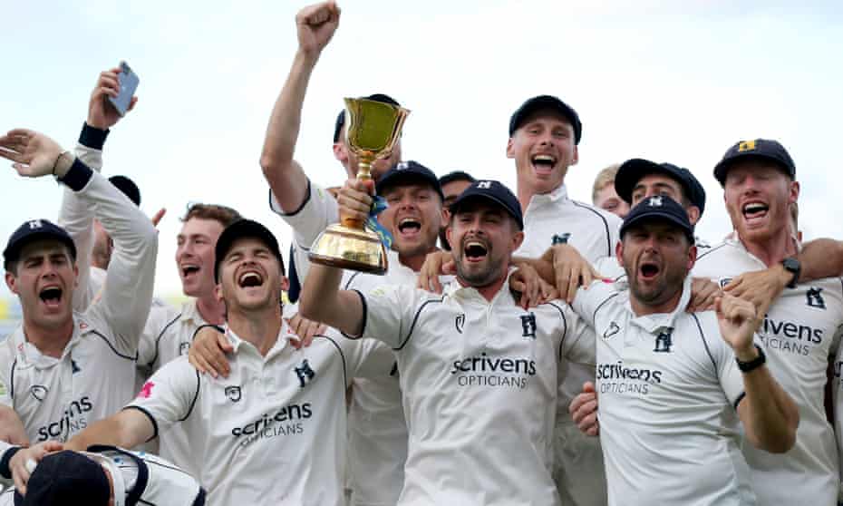 Warwickshire celebrate with the County Championship trophy at Edgbaston