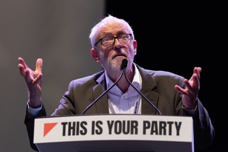 Jeremy Corbyn gestures while speaking on platform with a ‘This is Your Party’ sign in capital below