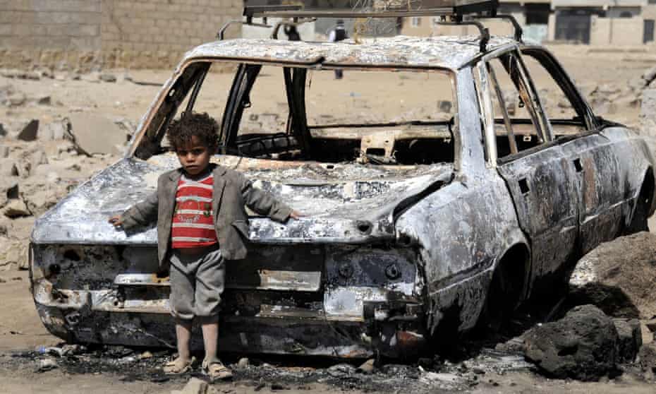 A Yemeni child next to a wrecked car after Saudi-led airstrikes in Sanaa, Yemen, in February 2016. 