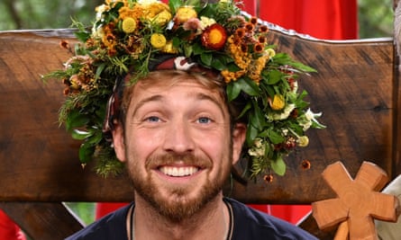 Sam Thompson wearing a headdress made of flowers 