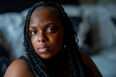 A woman with braids poses for a portrait