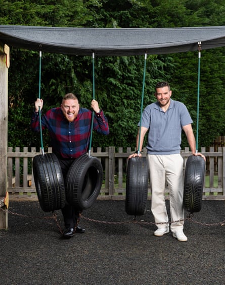 Adam and Lee Parkinson with tyre swings in a school playground.