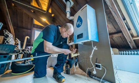 A worker installs a hydrogen boiler in an attic in Lochem, Netherlands.