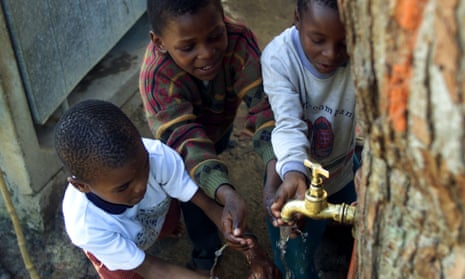 Children at a communal tap near Cape Town.