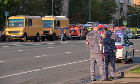 Emergency services vehicles and security forces personnel at the scene