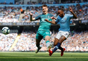 Manchester City’s Raheem Sterling puts in a cross despite pressure from Tottenham’s Juan Foyth.