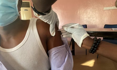 A vaccine dose is injected into the arm of a patient