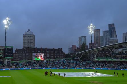 Ground staff bring on the covers during the Hundred eliminator game between Northern Superchargers and Trent Rockets at the Oval.