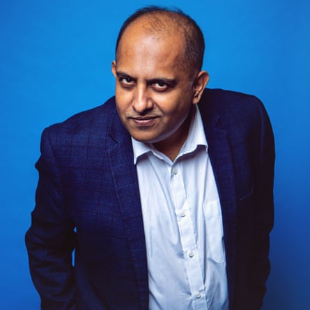Anuvab Pal leaning towards the camera against a blue background